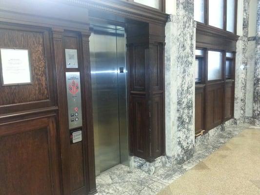 Marble walls and gorgeous cherry wood elevator enterence.