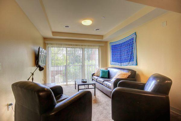 Living room with flat screen TV, balcony