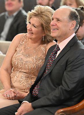 The groom's parents smiled at their son at the Bridge St. Wedding Chapel during the ceremony.  Candids are a highlight of Holmes Photography