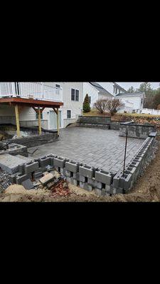 sunken patio with retaining wall, and stone stairs