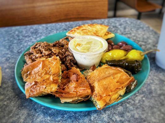 GREEK COMBO $17.49 Gyro Meat (Lamb, Beef or Chicken) Pita Bread, Spinach Ple & 2 Dolmades