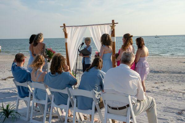 Treasure Island waterside ceremony for two ladies in love. The All Inclusive Beach Wedding Package includes an arch, chairs & simple runway.