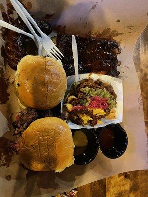 Spare ribs, House Frito pie sausage link, Frito pie, chopped brisket sandwich and a smoked cheeseburger.