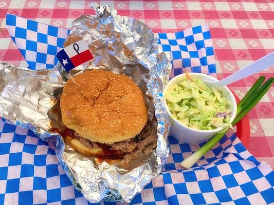 Pork sandwich with spicy bbq sauce and cole slaw.