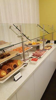 Danishes, the meat & cheese, olives and on the end, close to the wall, shrimp & crab