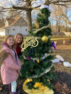 Zoe and Grace, Attorney Sara Reedy's daughter, decorating a tree for Prestige Way in Holt