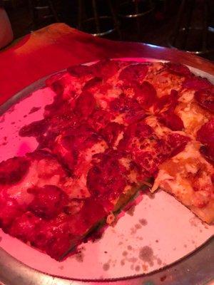 Terrible picture of delicious pepperoni and sauerkraut pizza.