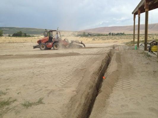 Big and small trenches, they do it all. Trenching for the Frichette Winery irrigation system on Red Mountain.