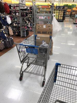 Baskets in the middle of the walking path and carts they use to stock with left unattended.