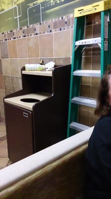 Cleaning supplies and a ladder right by the front counter during the breakfast hour