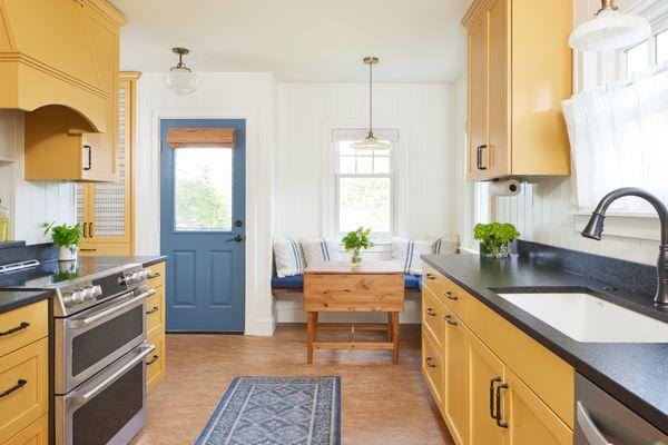 Cottage Kitchen in West Seattle boasts  classic color combination of yellow and blue.  Design by Raina Henderson Interiors