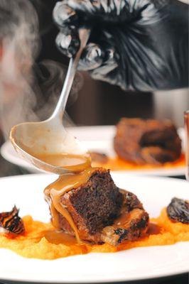 Bison rib served over carrot purée and seared pearl onions.