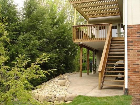 Keystone poured a slate textured concrete patio underneath the deck, connecting the stairs...