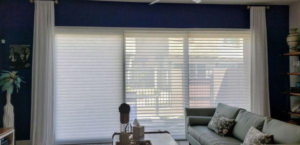 Electronic shades for 12' patio door with same privacy during day with light or total privacy at night when closed.