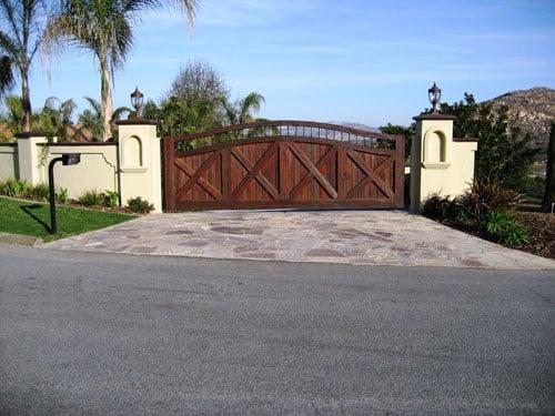 Large wooden driveway gate w/stone entrance