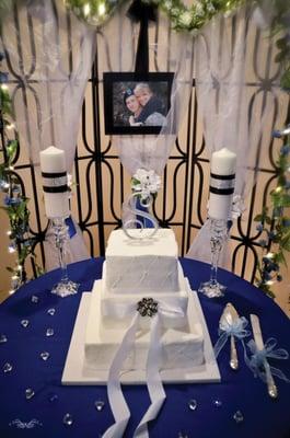 Wedding Cake backdrop. Includes backdrop, 8x10 frame, candles and Crstal Stands, Cake/knife set, crystals, Garland, linens