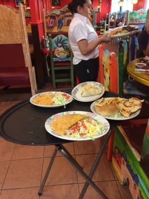 A selection of a few of the meals being delivered to a table nearby