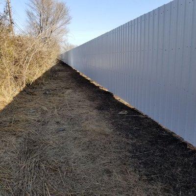 700' of 8' sheet metal! What a beast of a fence. Welded rails and screws every 6".