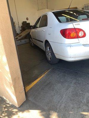 My car being inspected for smog