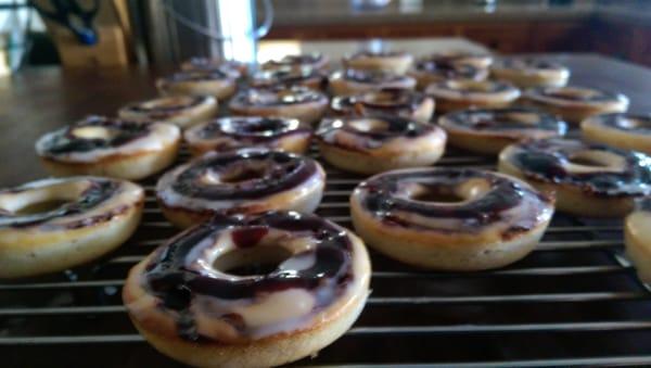 Baked Lemon donuts w/ blackberry cabernet glaze.