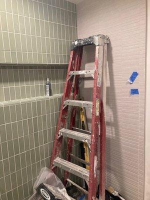 Our newly tiled shower.  Excuse the construction ladder.