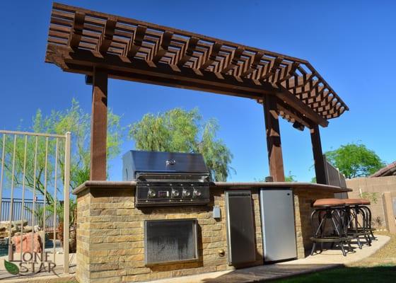 Built-in BBQ with bartop, fridge, shade structure and lighting.