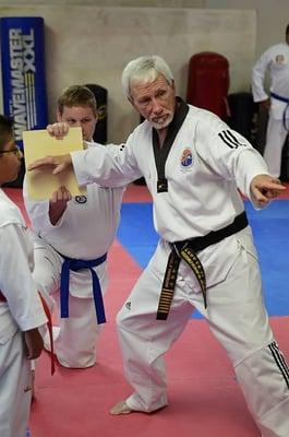 Grand Master Anderson instructing a student during a belt test.