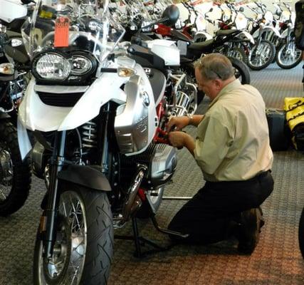 Tommy installs bags on a customer's new bike.