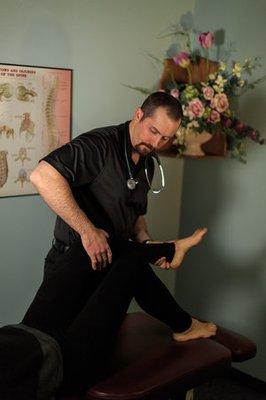 Dr. Barringer using Active Release Technique on a patient for sciatica and knee pain relief