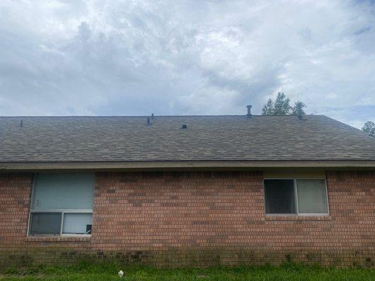 Shingles lifting up, you can see bowing in-between exhaust pipes.