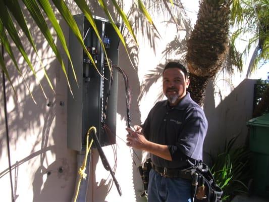 Solar electrician at work re-wiring the panel.