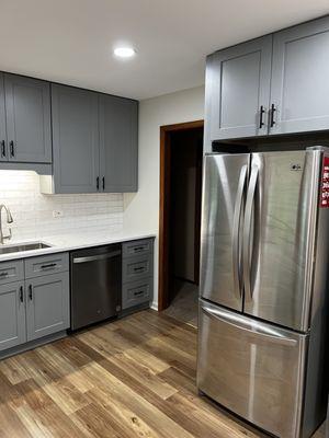 Refrigerator with extended cabinet overhead with side panels