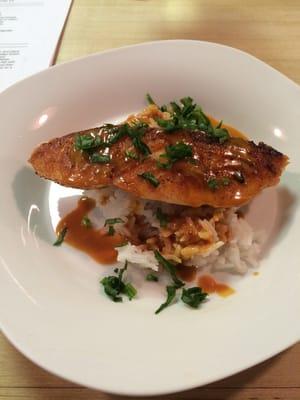 Salmon over jasmine rice with a shrimp sauce.