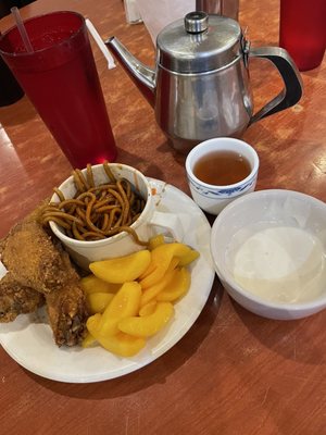 Chicken wings, peaches, noodles with sweet and sour sauce. To drink hot tea and water plus a bowl of blue cheese