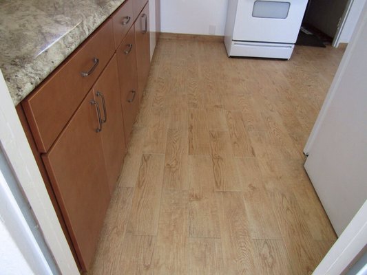 Gorgeous porcelain wood look tile floor with matching baseboard trim tile