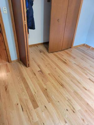 2-1/4" pre-finished natural red oak flooring with new treads and risers that are installed and finished on site.