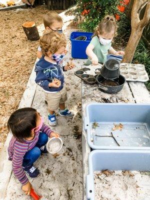 Our 2-year-olds playing in the mud kitchen