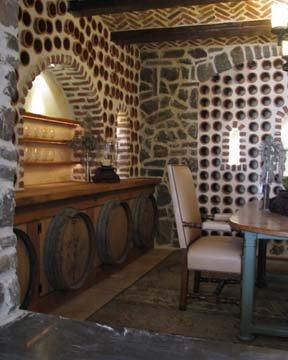 Rustic white oak cabinetry with terracotta pipe wine cellar.