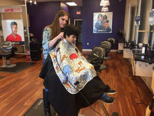 The child thinks he's getting a story while the mom is happy to get his hair cut :-)