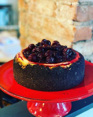 Freshly made cherry topping over rich cheesecake in an Oreo cookie crust