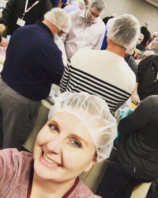 Rocking hair nets (and beard) as we package food packets