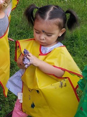 A 1-year-old little girl enjoys sensory with paint!