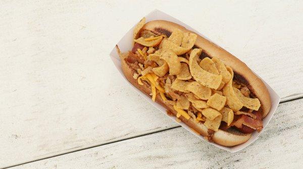 Demo Day Dog - A Quarter Pound of all beef dog loaded with Dr. Pepper chili, cheese, bacon, crispy onions, and Fritos!