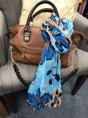 Perfect fit Manager Heidi dressed this handbag up with a beautiful scarf.   Both of these items are donated.