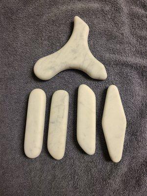 Deep tissue cold stone set. The different tools are used to better access areas of discomfort and tension while reducing pain and swelling