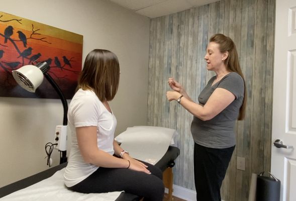 Dr. Lisa explaining how an acupuncture treatment is administered.