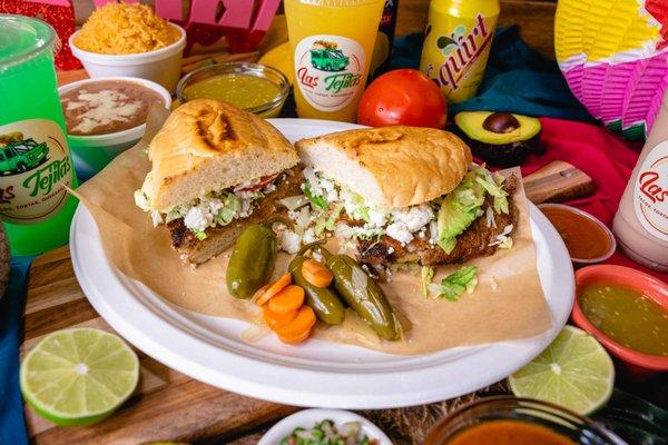 A Mexican Torta resembles a sandwich in almost every way: a crusty roll is sliced in half and filled choice of meat, lettuce, tomatoes & avo