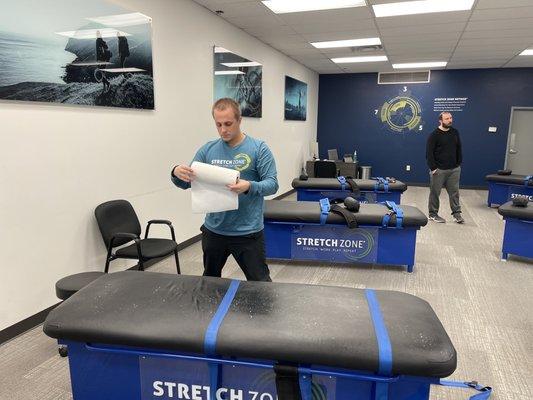 Interior view of Nick Vankleeck, General Manager, sanitizing a table after use