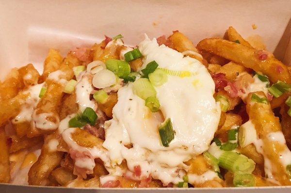 Sunnyside Fries. Sauce, spices, egg, scallions, and bacon.