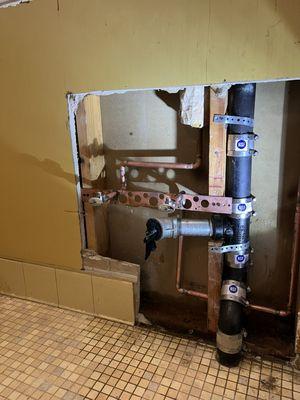 Install new cast-iron drain pipes for the commercial restroom sink and new hot and cold water lines